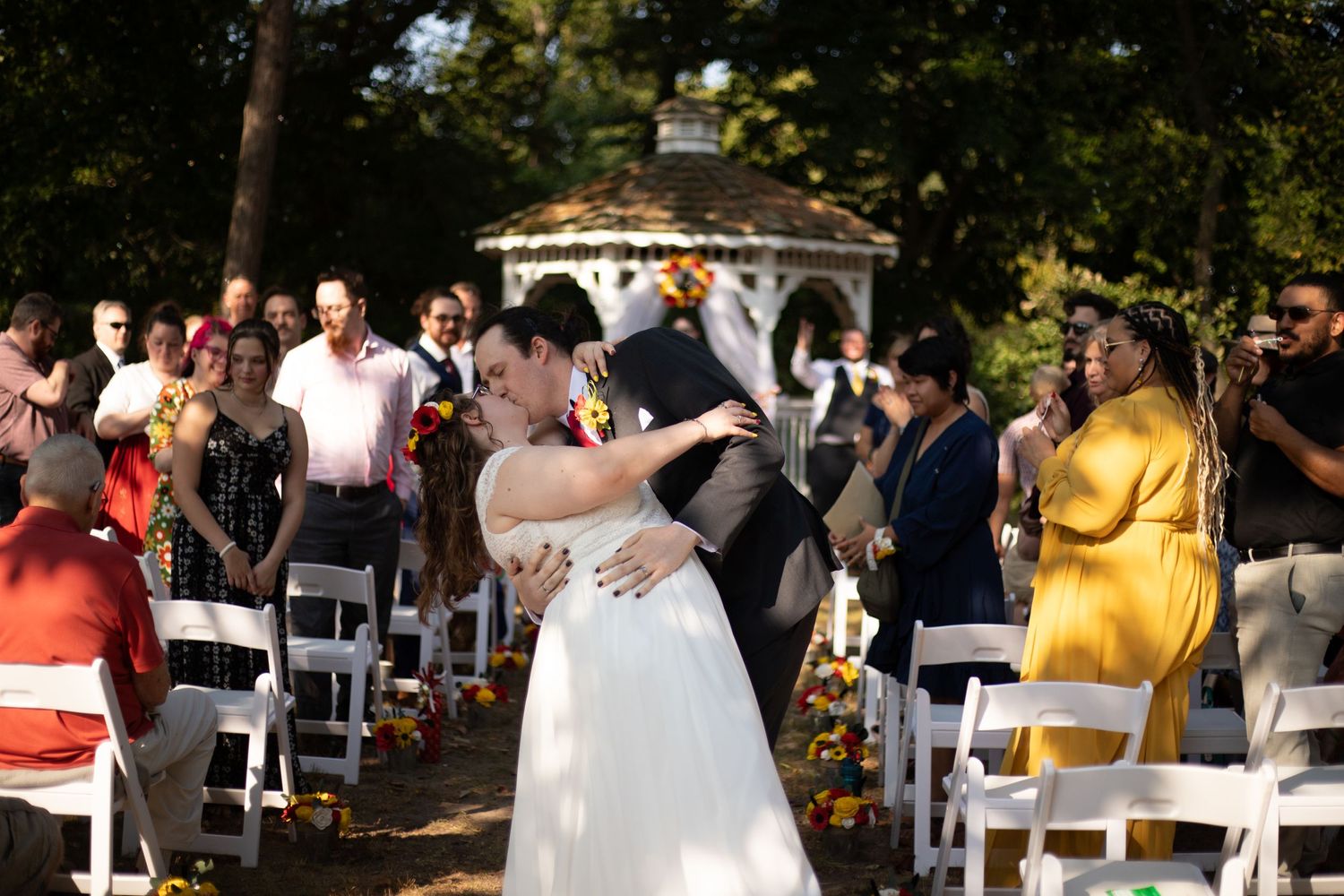 Bride and Groom sharing a kiss with a dip at the end of the isle at wye island, a wedding venue on a budget.