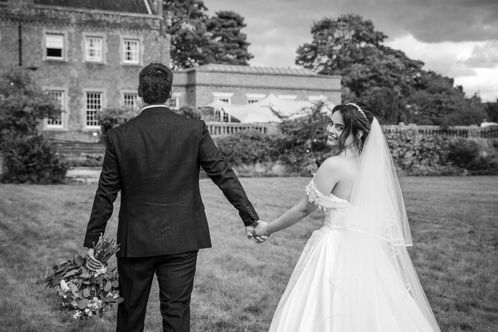 A black and white wedding photo collage showing romantic outdoor moments with a couple in formal attire.