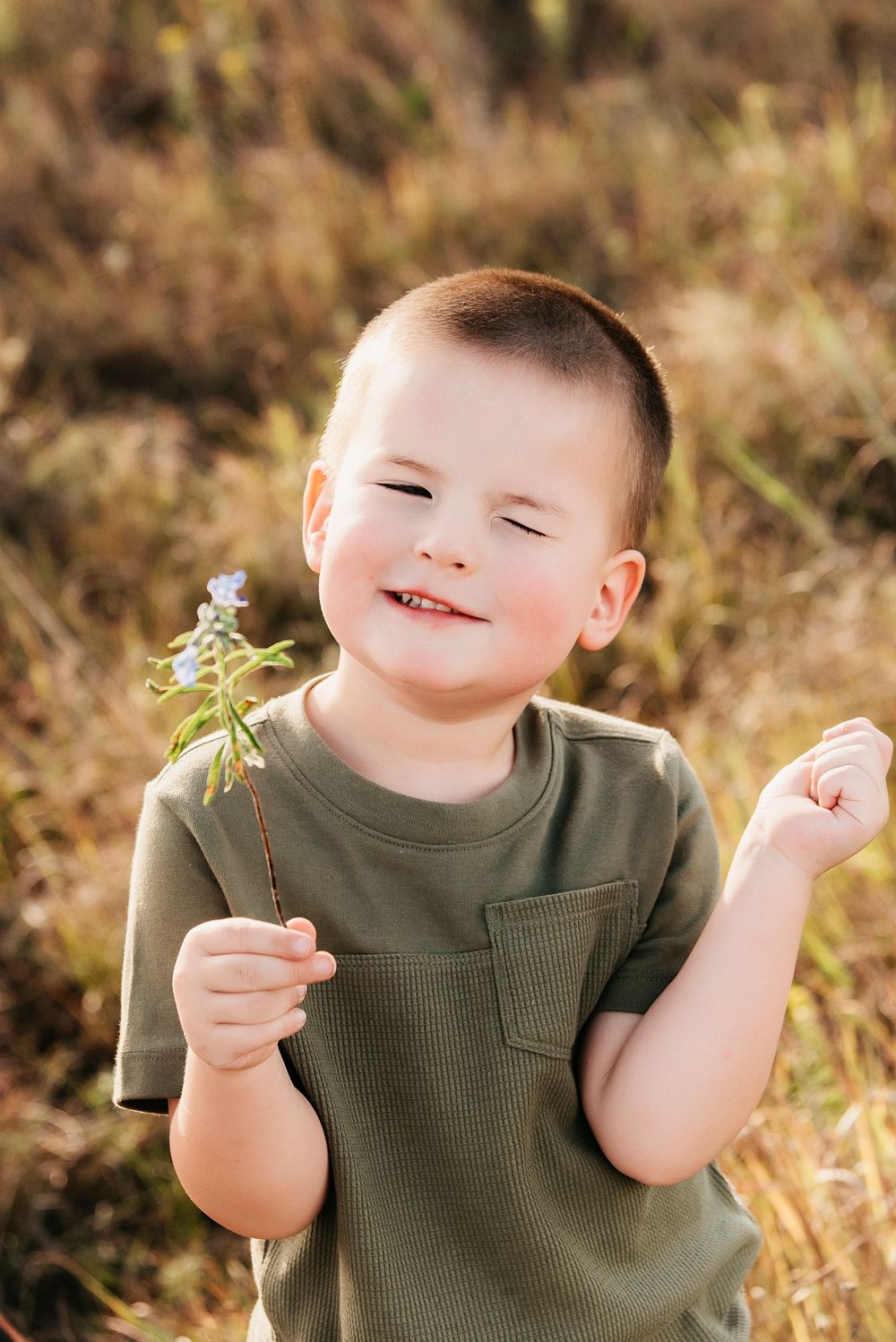 Close-up sequence showing joyful expressions while holding small wildflowers in the sunlight.