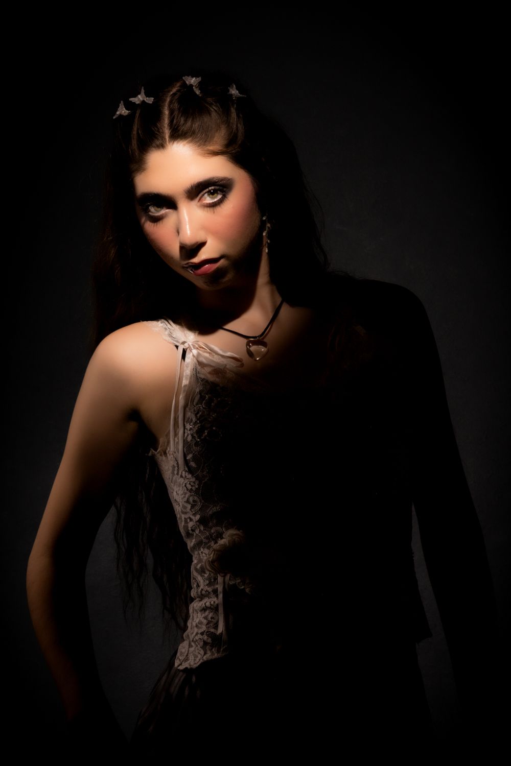 Dramatic black and white portrait series with moody lighting showcasing an artistic tattoo design.