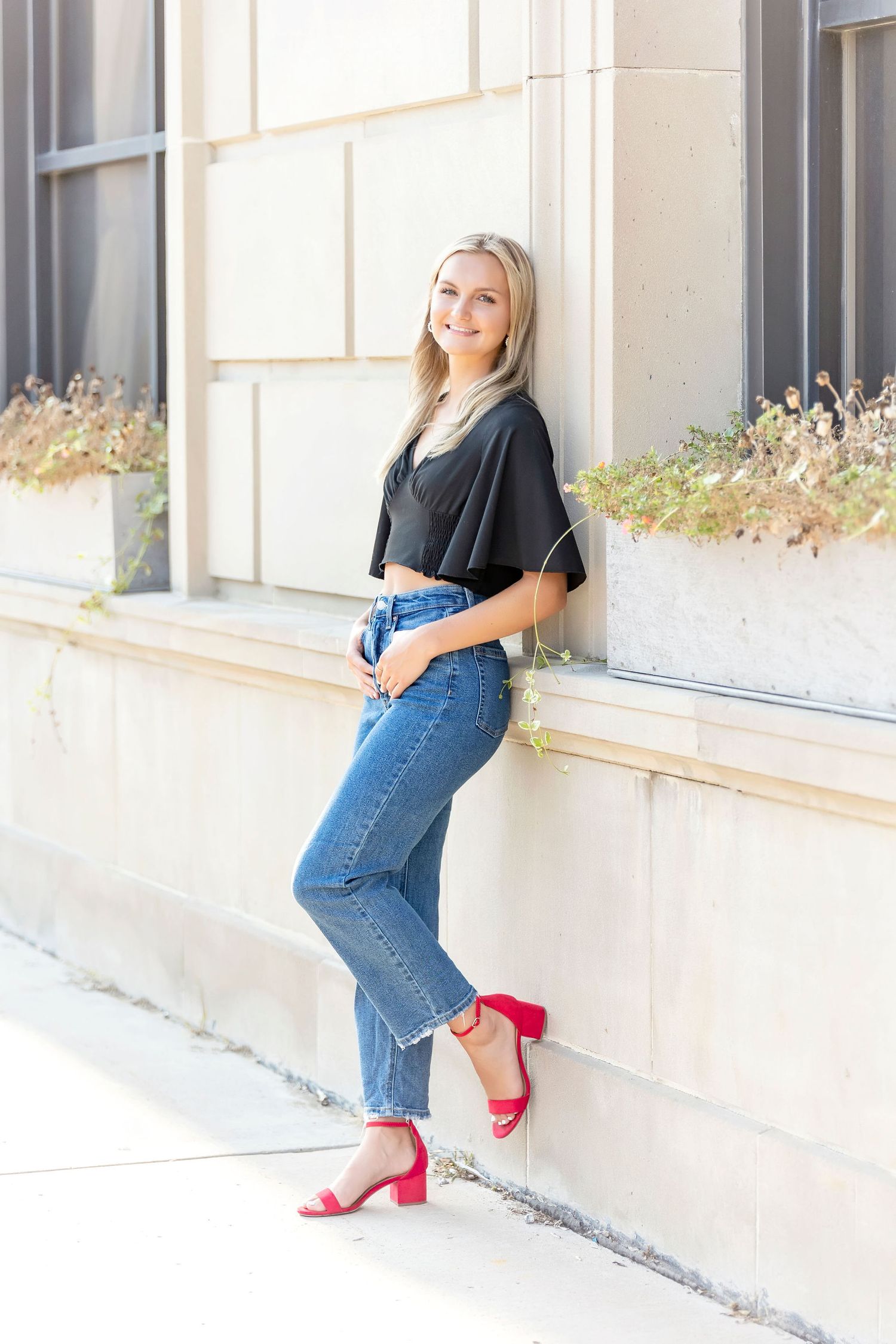 High School Senior photo standing outside of The Manor in Mason City, Iowa.