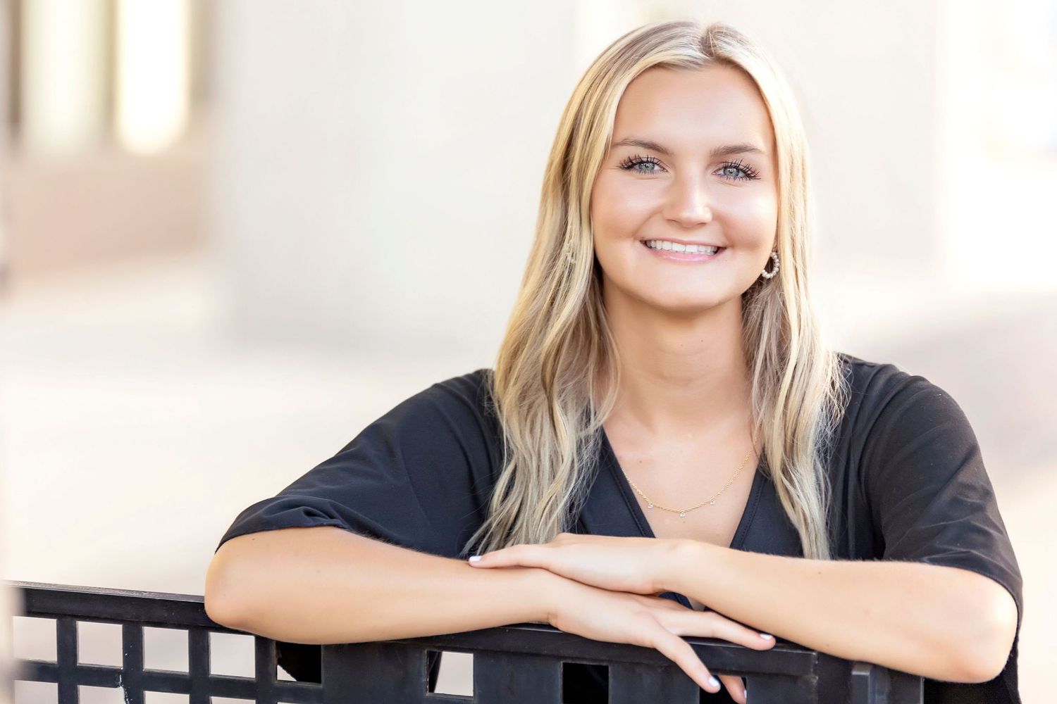 Senior portrait headshot of girl in black blazer, soft outdoor lighting, Mason City senior session.