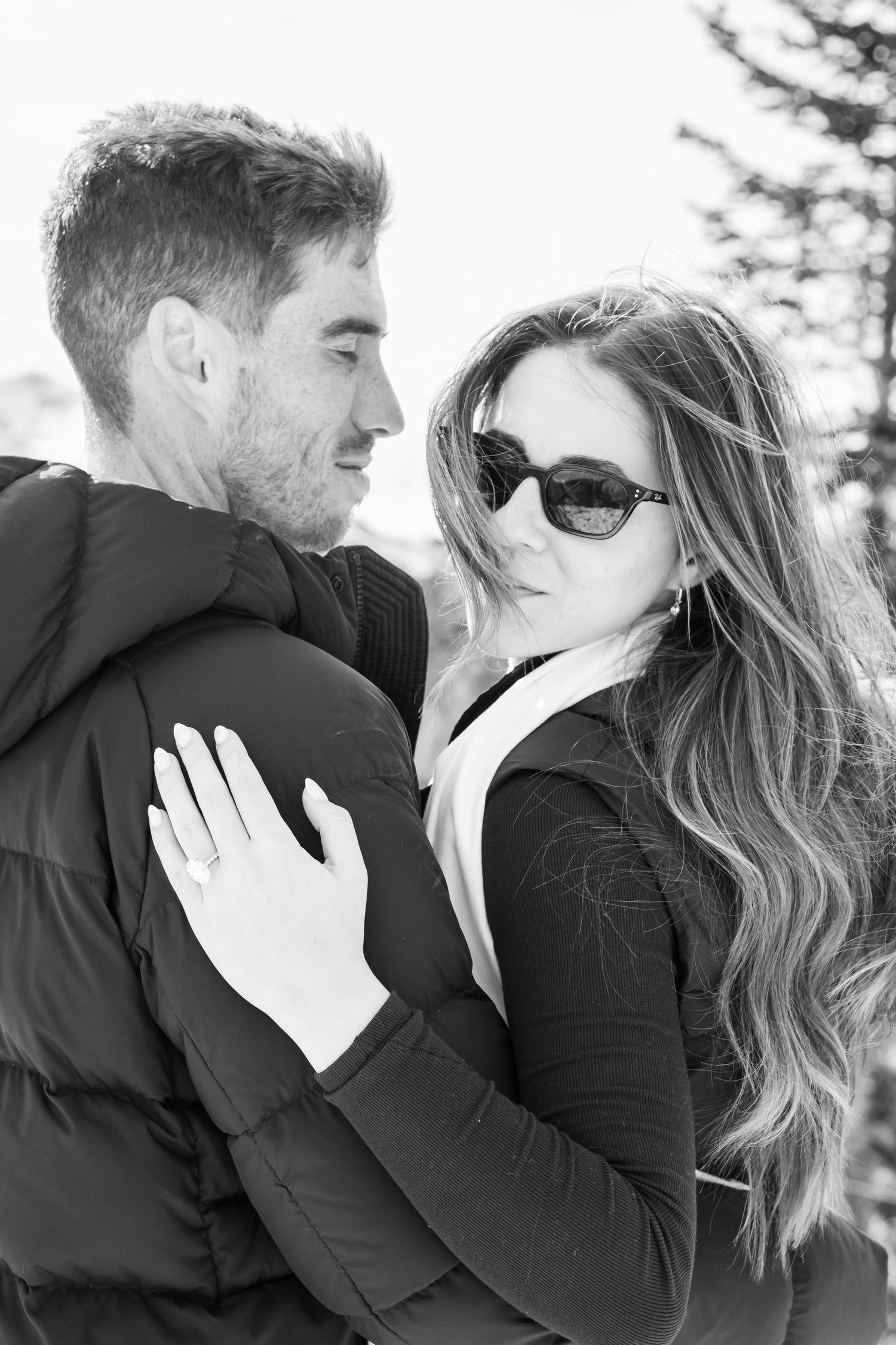 Chic and editorial black and white photo of a stylish young couple on top of Aspen mountain after a surprise proposal.