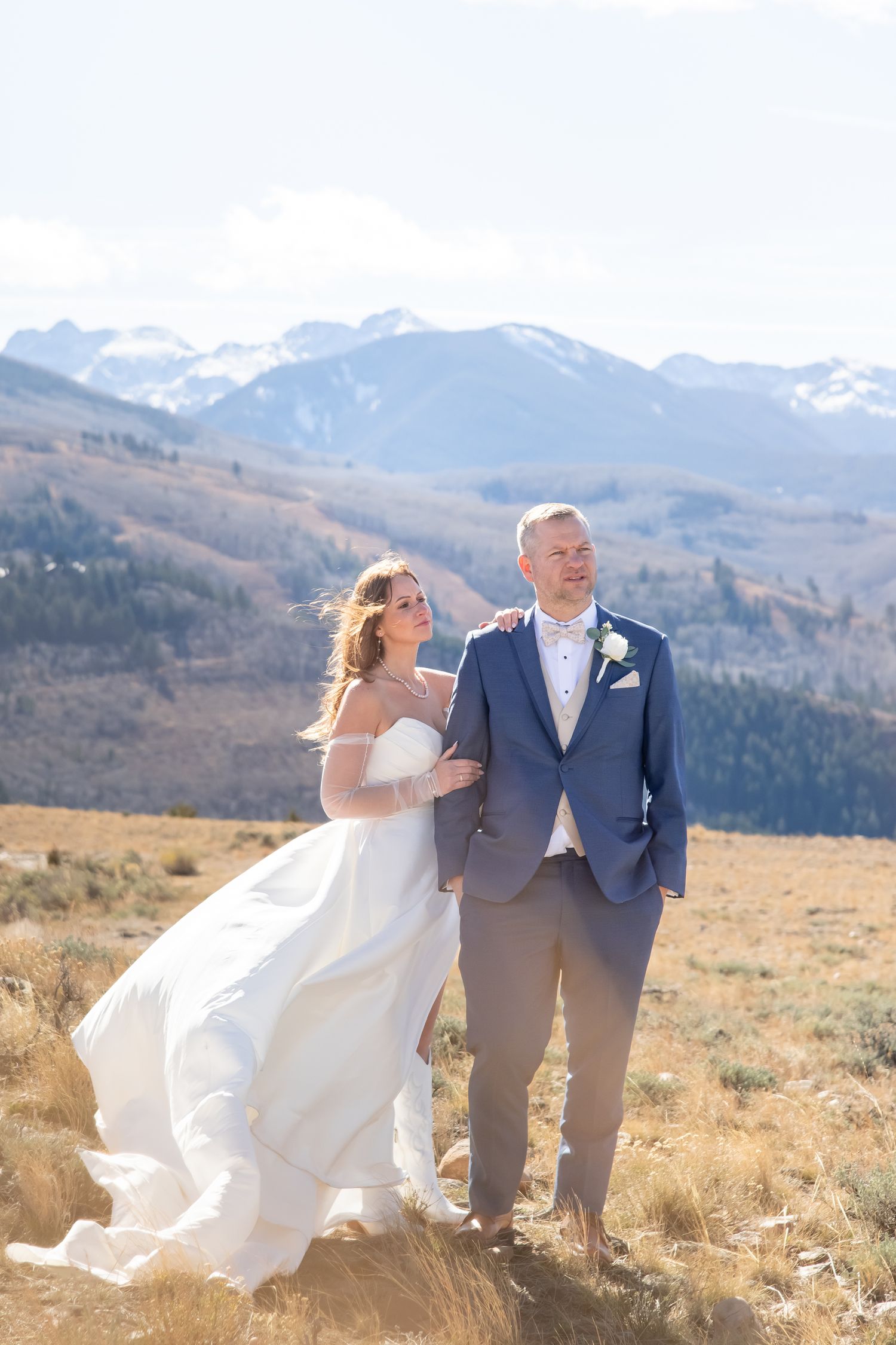 Beaver Creek wedding photo of bride and groom gazing into the distance with mountain peaks behind them