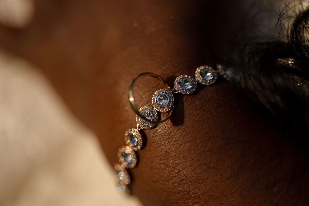 Macro shot of sparkling diamond jewelry against dark background.