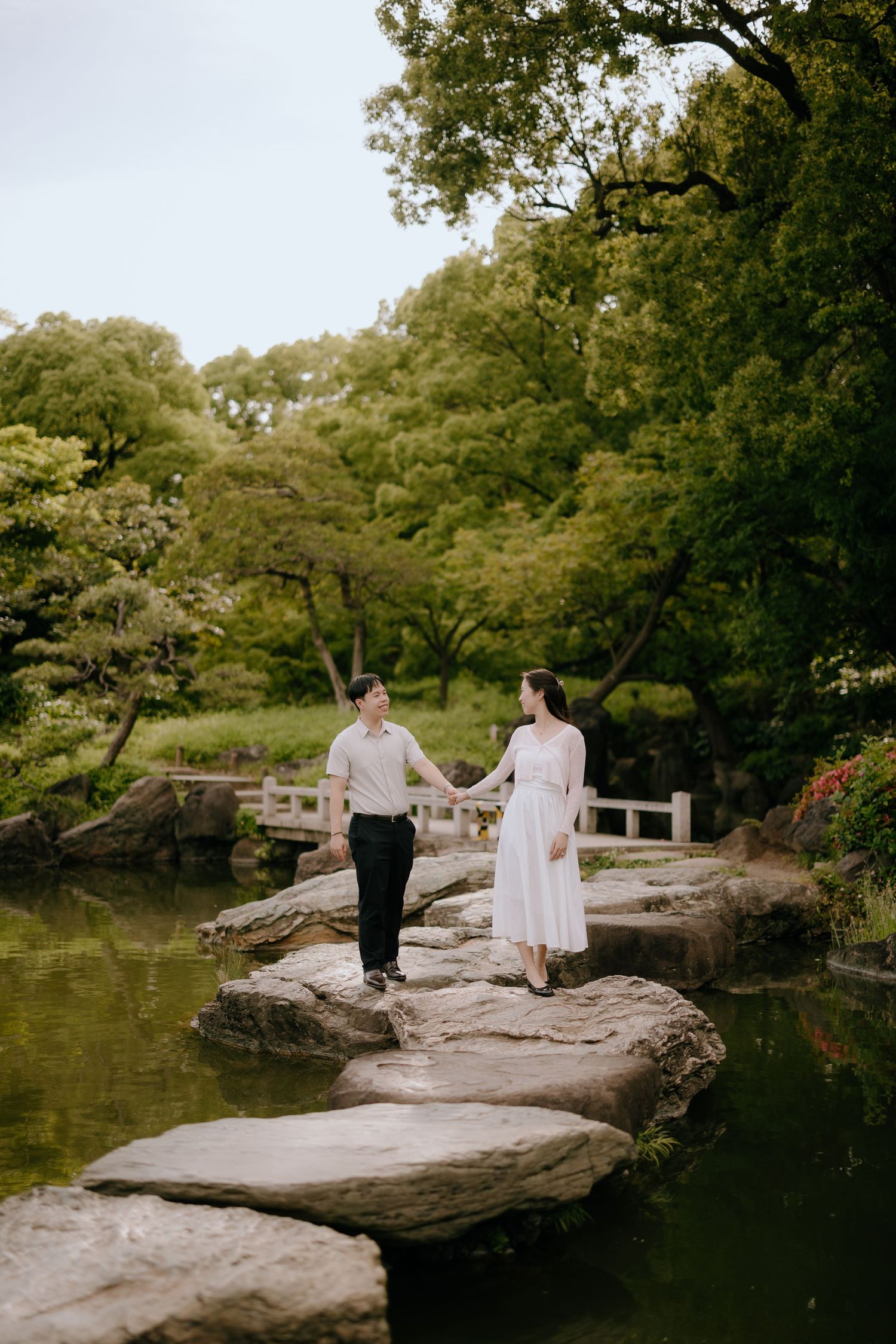 Proposall photo by serene pond with traditional Japanese stone lantern in tranquil Shinjuku Gyoen national garden Tokyo