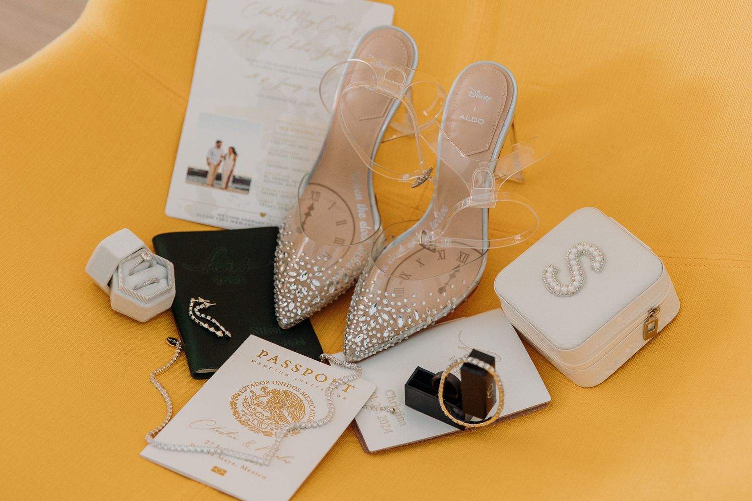 A collection of elegant bridal shoes and accessories arranged on a bright yellow background. El Dorado Royale Wedding Photographer