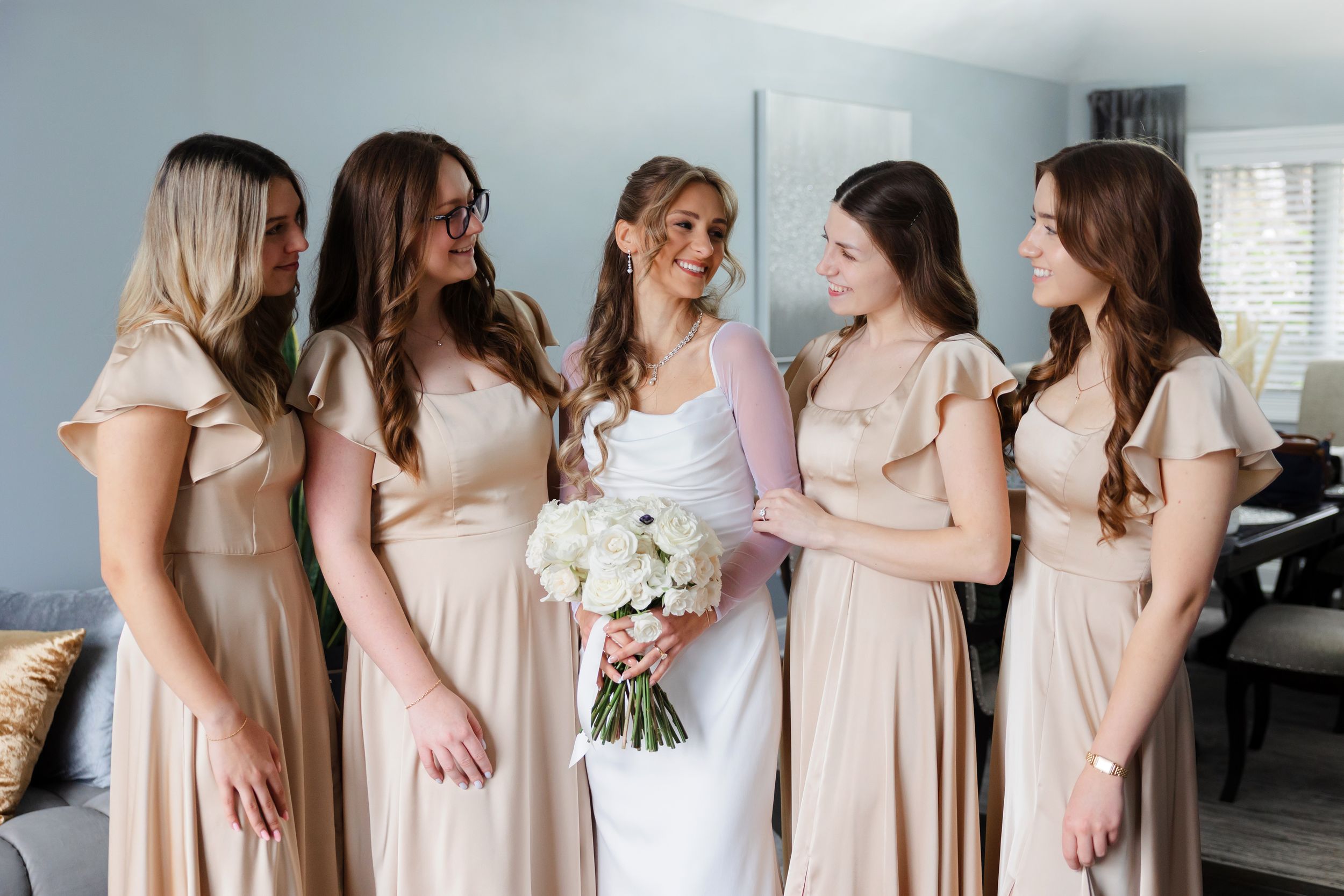 Bride and bridesmaids smiling before ceremony captured by Tom Forrest Photography from Hudson, Ohio.