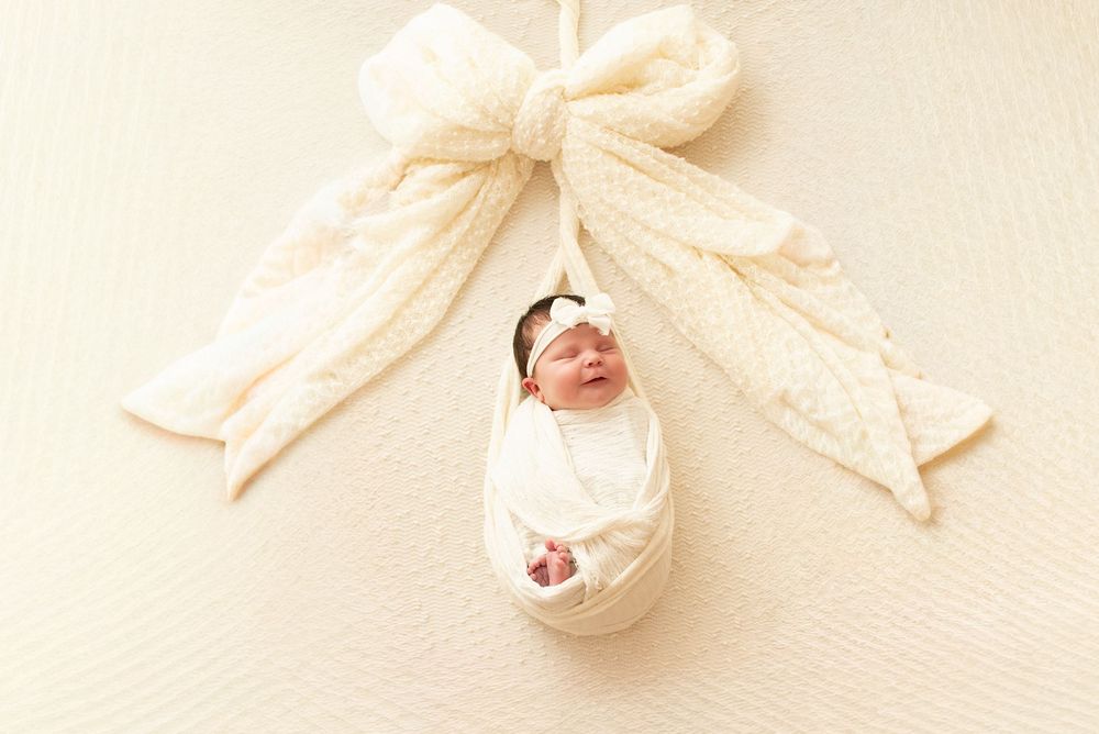 Series of delicate cream-colored fabric wraps arranged artistically.