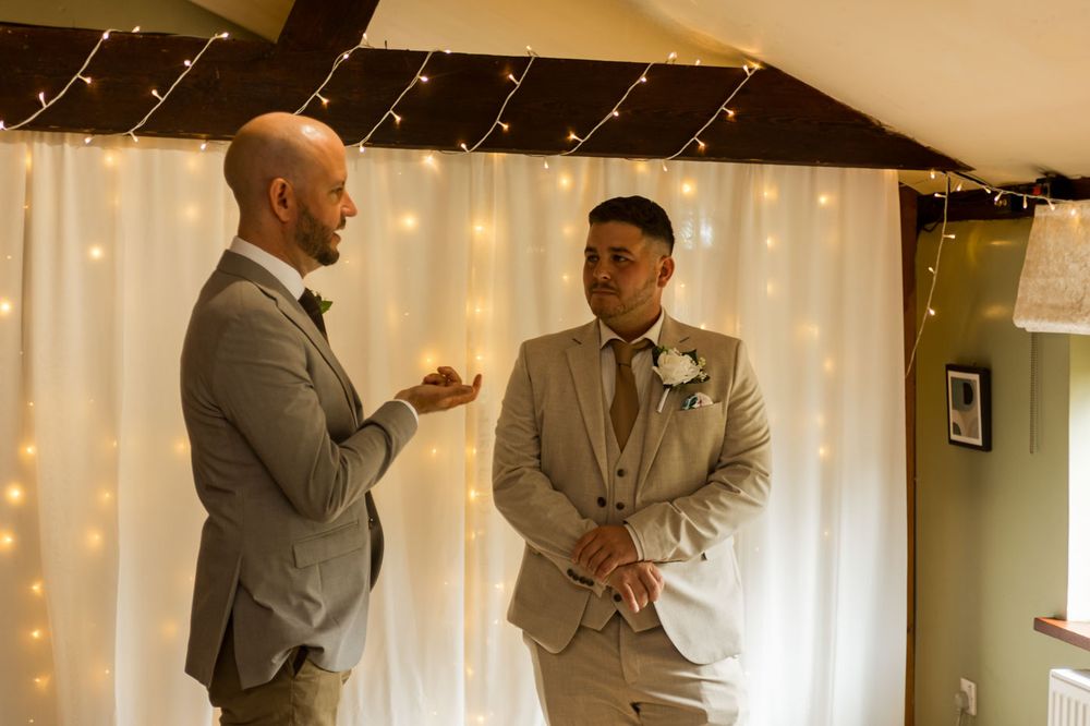 Groomsmen sharing emotional moments before the wedding ceremony.