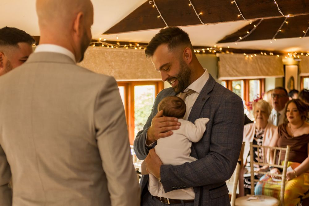 Emotional moments shared between wedding party members in formal attire.