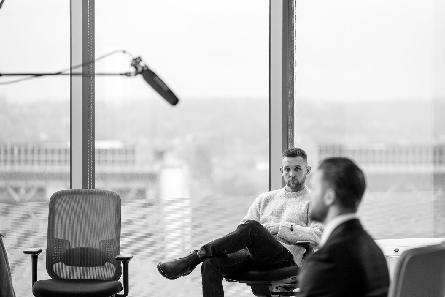 Behind the scenes view of a corporate video production setup with camera equipment and crew.