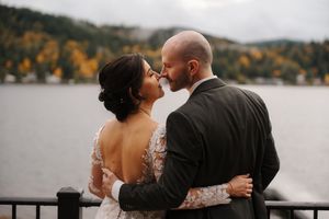 A romantic wedding photo collage showing tender moments between a couple against a scenic lakeside autumn backdrop.