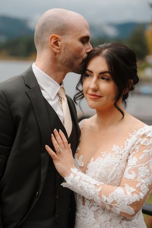 A series of intimate wedding portraits showing a couple in formal attire embracing by a misty lake.