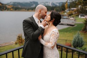 Newlywed couple shares romantic kisses in multiple scenic outdoor locations during their wedding photoshoot.