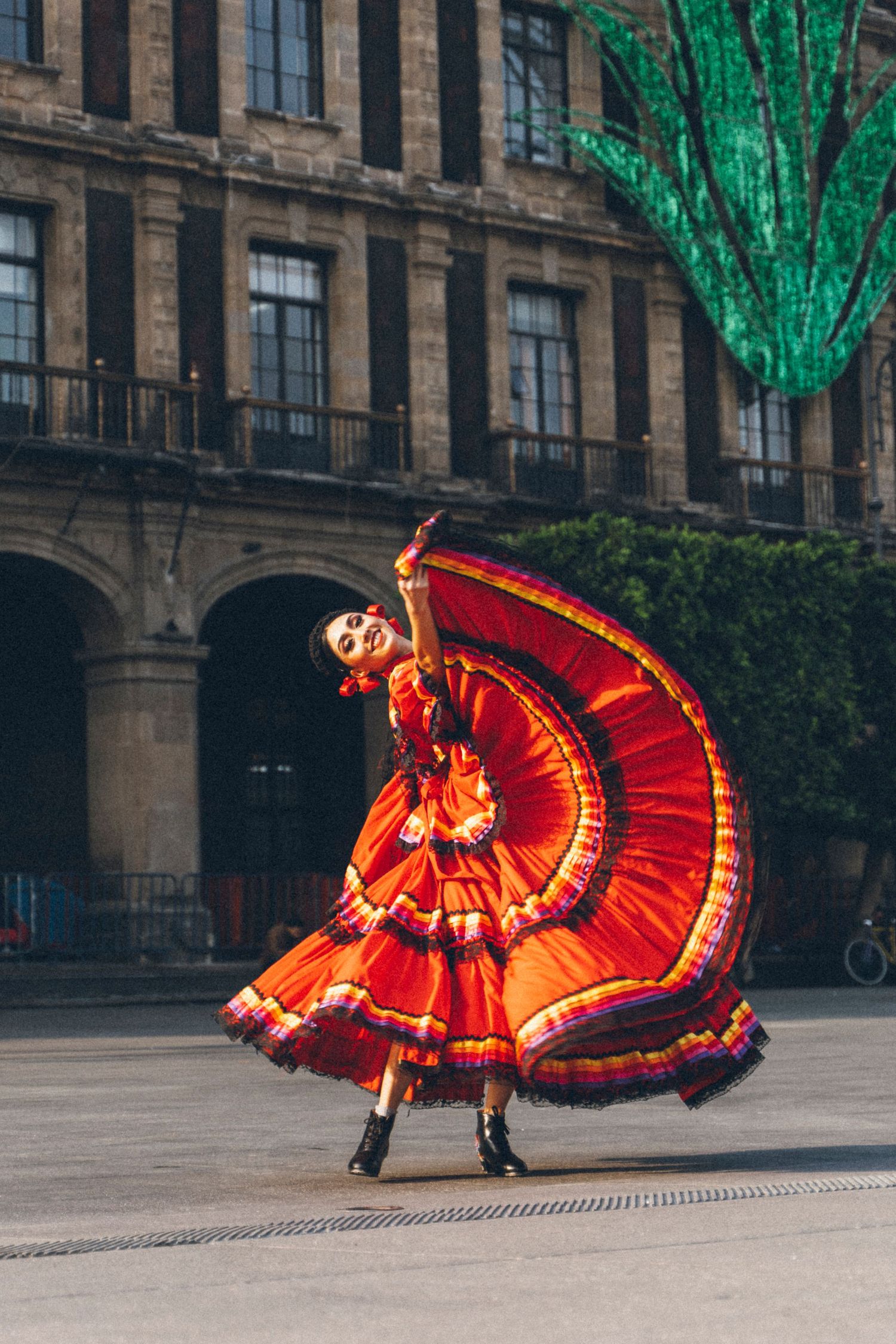 Ballet Folklórico de México dancer performing traditional movement near Mexico City Metropolitan Cathedral