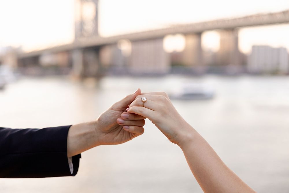 Close up view of two hands exchanging a white business card against a blurred background.