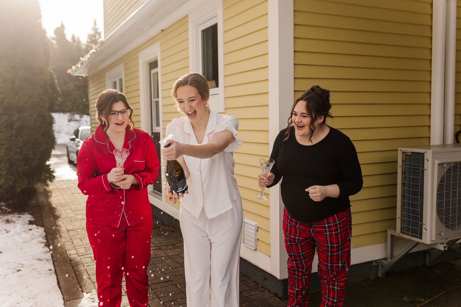 A series of five candid photos showing people dancing and celebrating together outside a yellow house in winter.