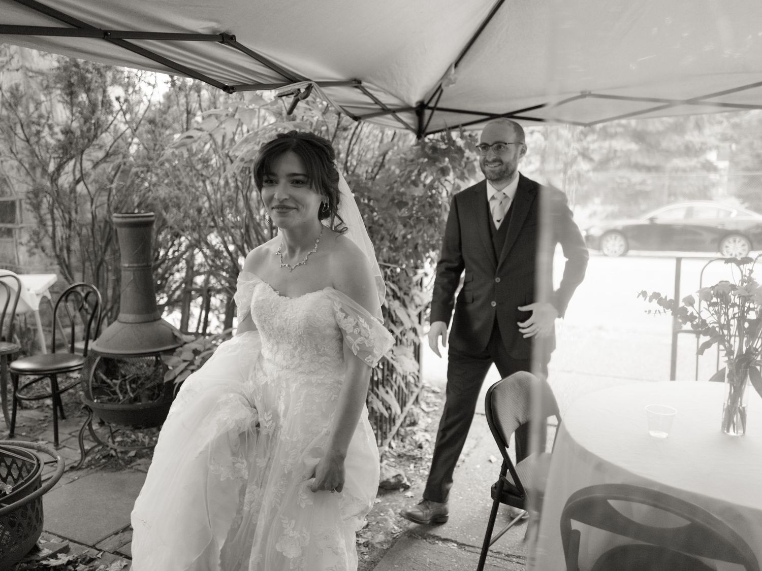 A couple walks together under a covered outdoor walkway during a special celebration.