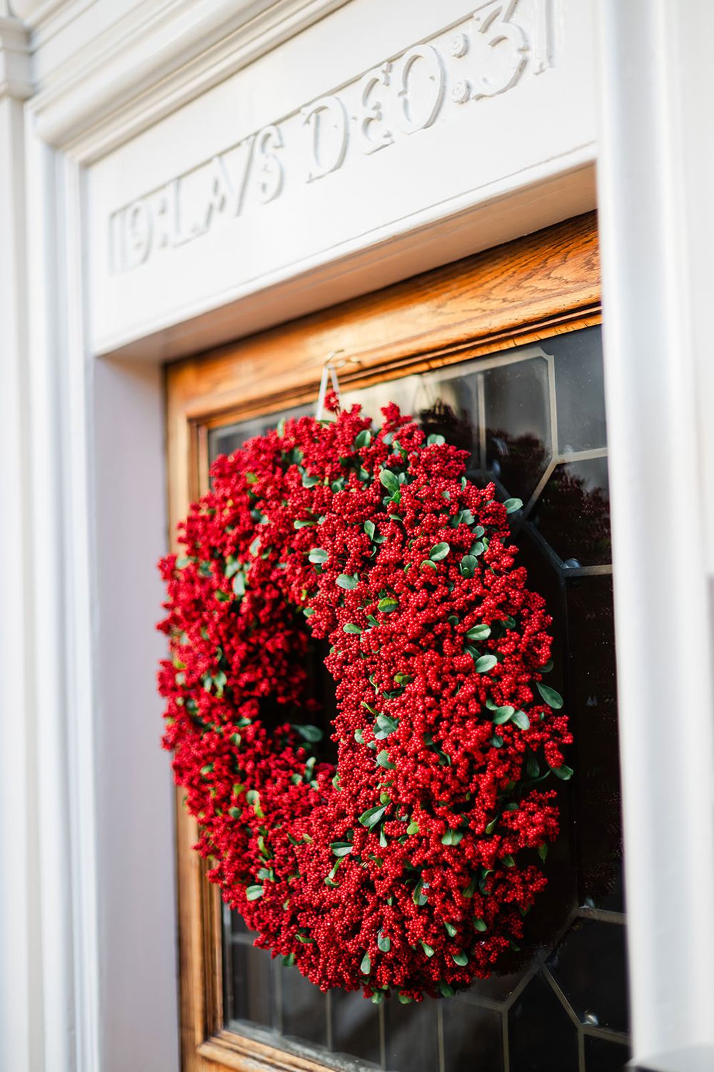 Beautiful red heart-shaped floral wreaths hanging on white doors create a romantic Valentine's Day decoration.