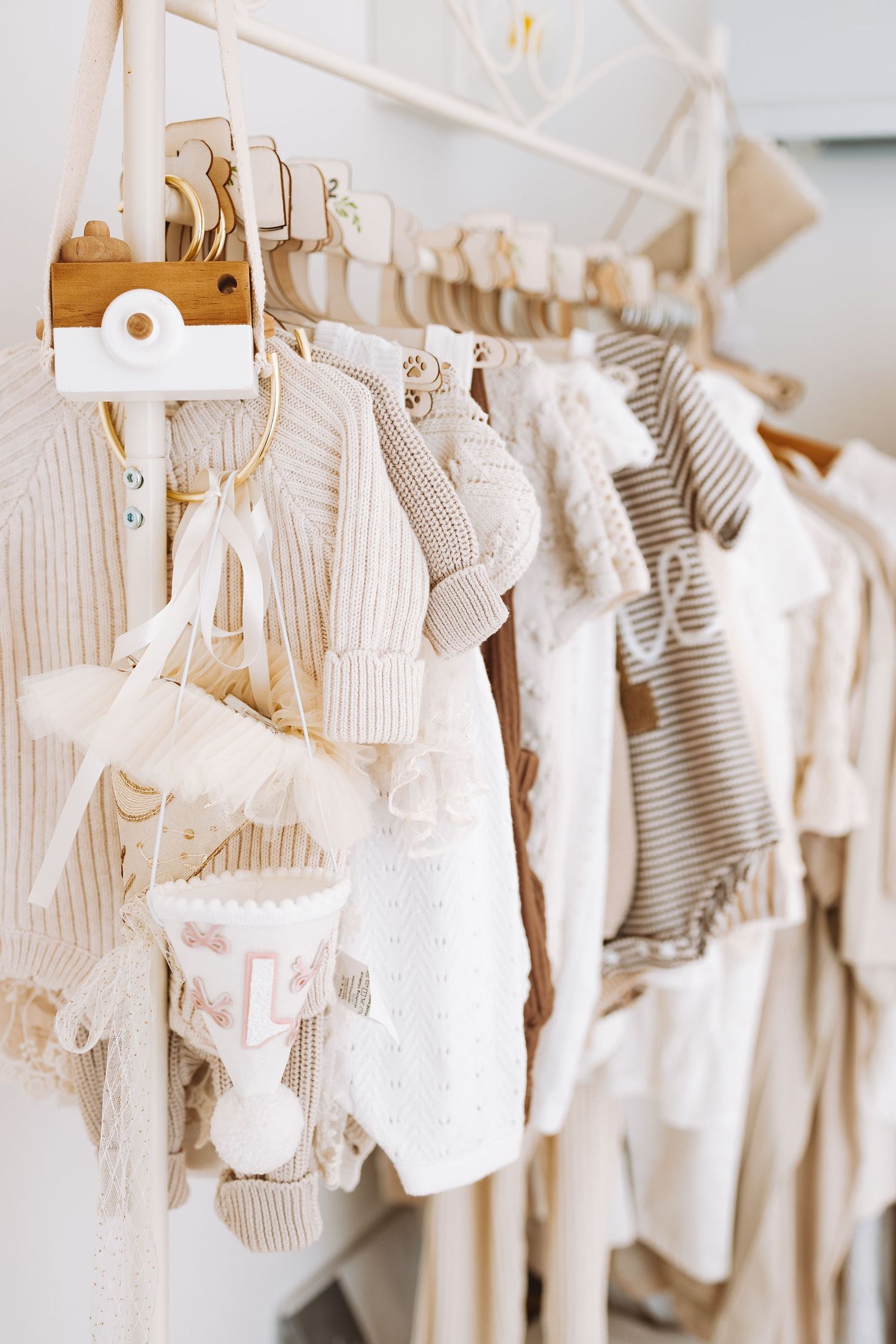 White mannequin torso form displayed with stacked pancakes and white balloons in a minimalist studio setting.