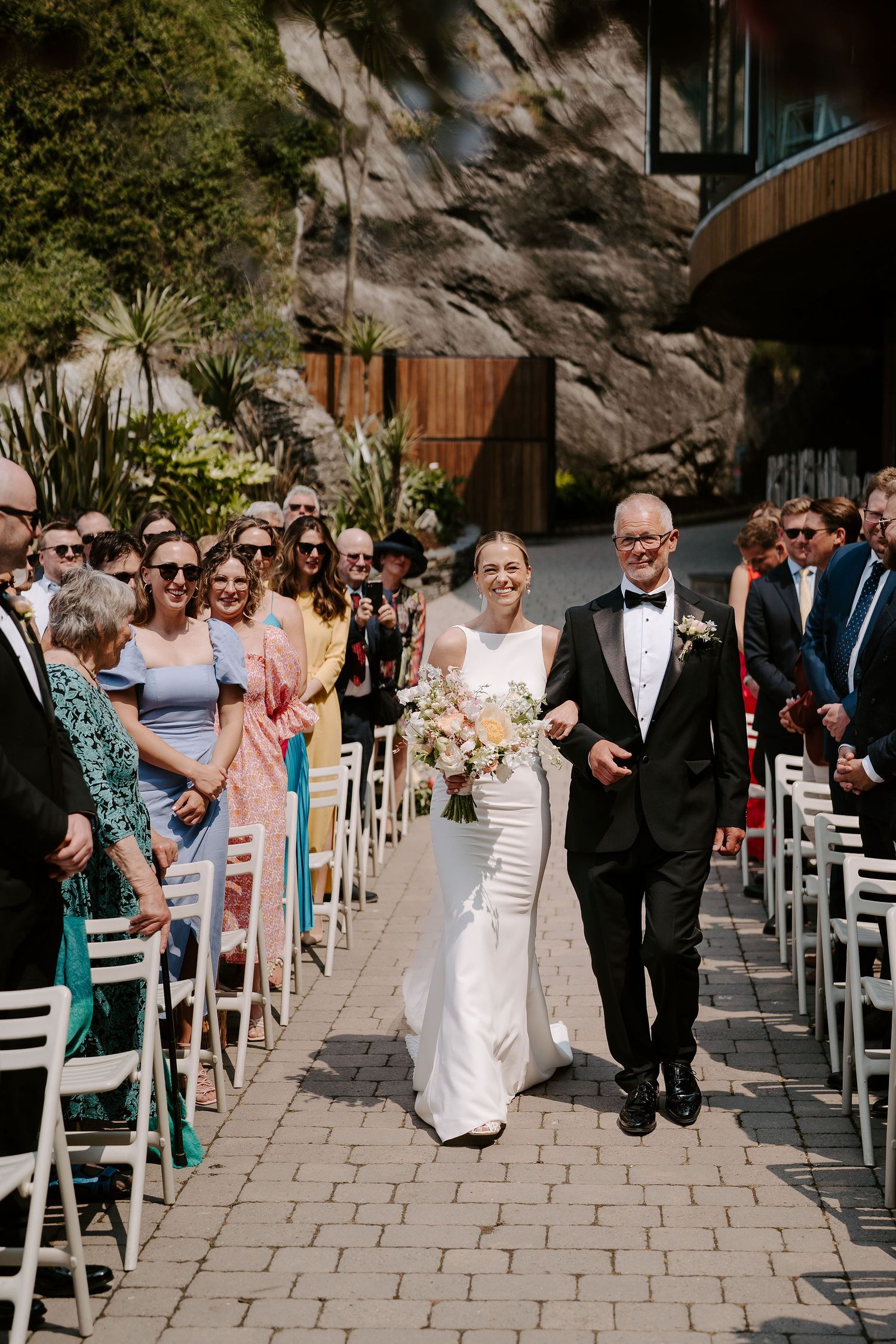Tunnels Beach Wedding Venue in North Devon, Bride and Dad walking down the aisle towards the groom
