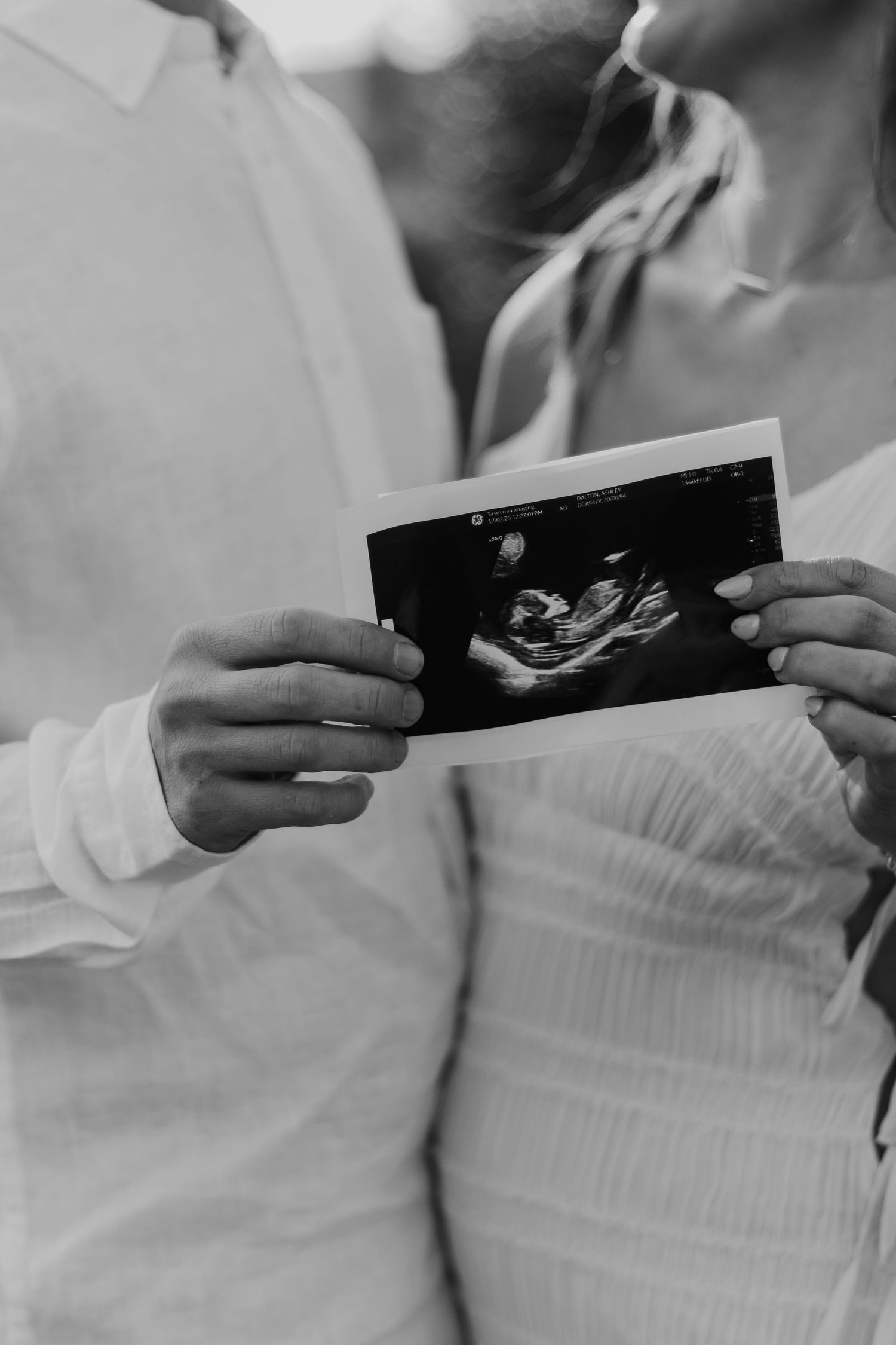 Close up of a expecting parent holding the sonogram of their unborn baby