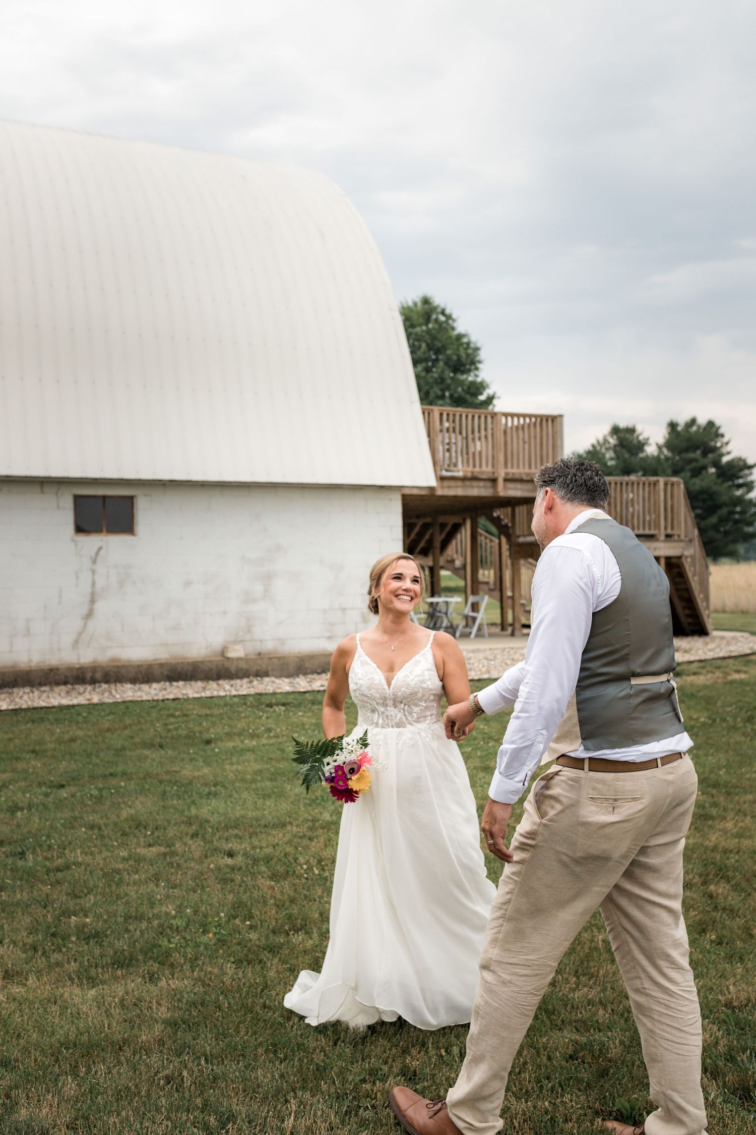 Candid wedding moments captured outside a rustic barn venue.