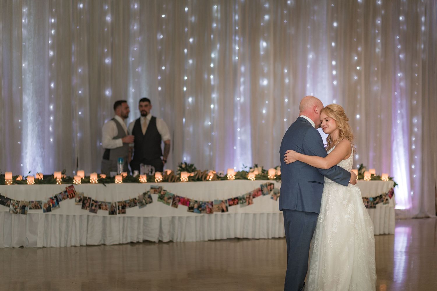 Wedding reception space with cascading fairy light curtains creating a magical atmosphere.