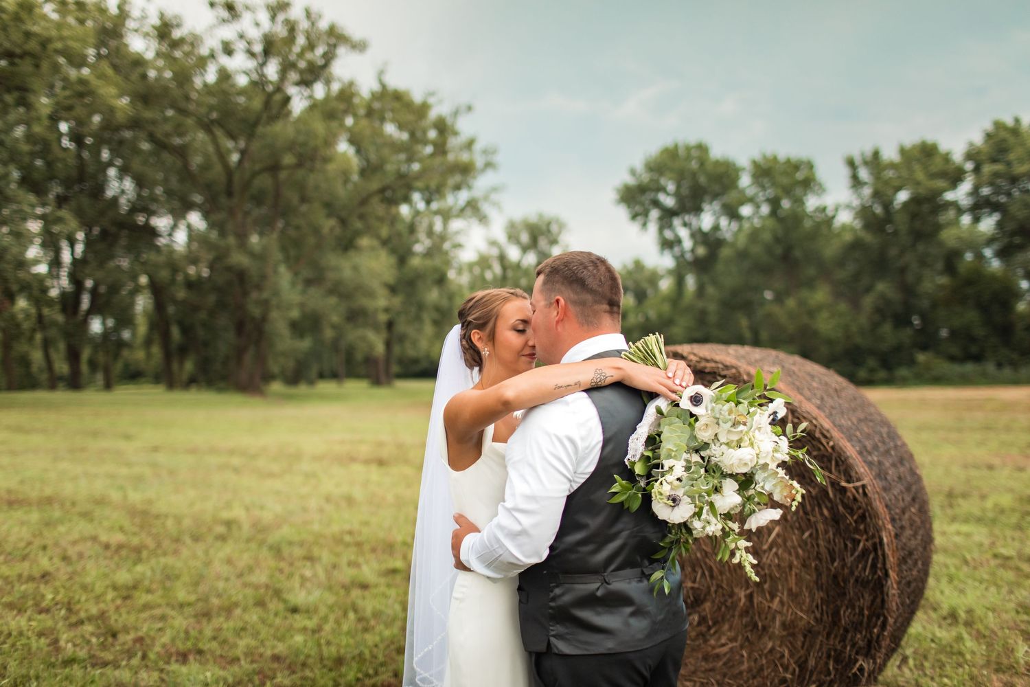 Wedding celebration in a scenic outdoor setting with lake views and natural landscaping.