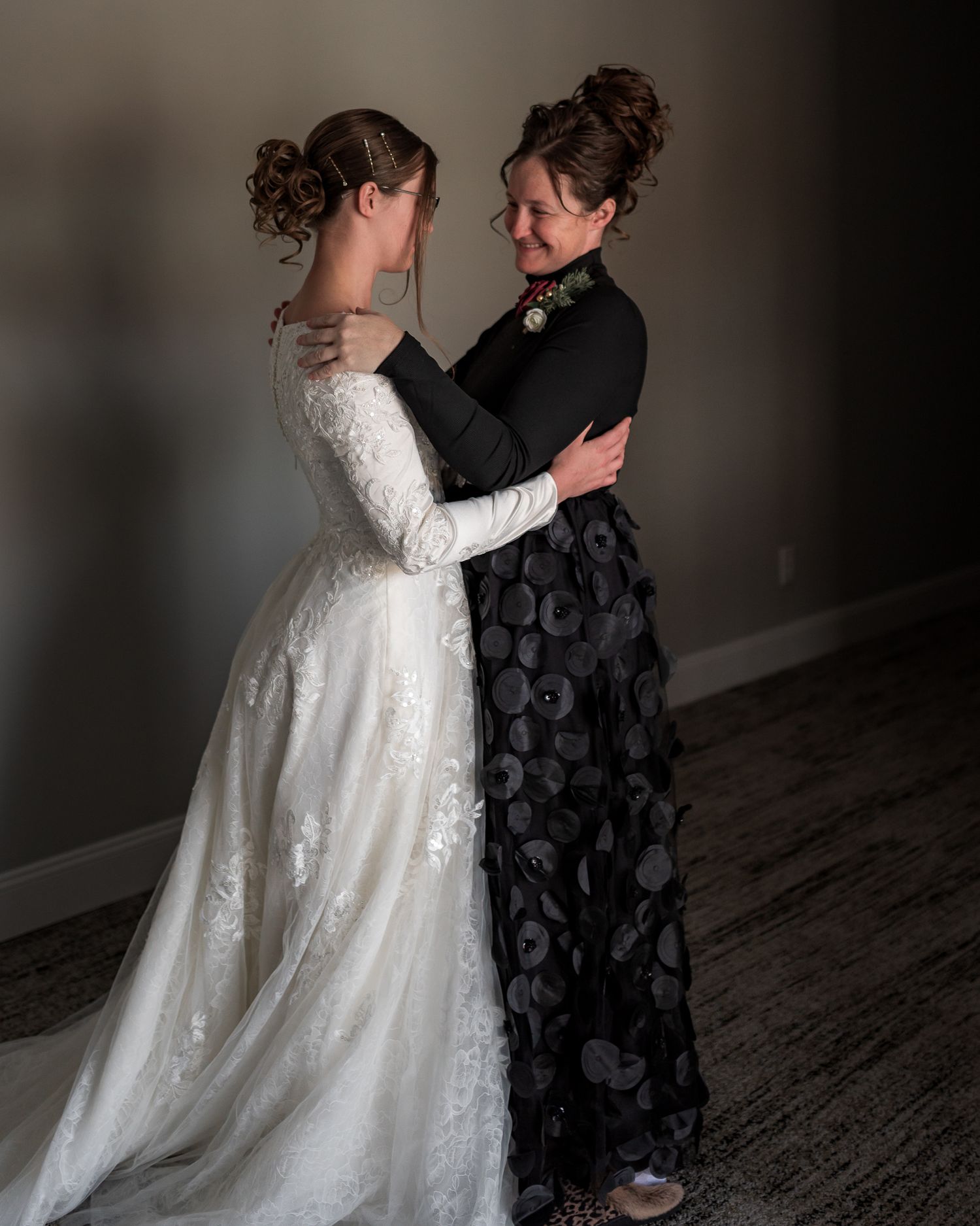 A romantic first look moment between a couple on their wedding day in dramatic lighting.