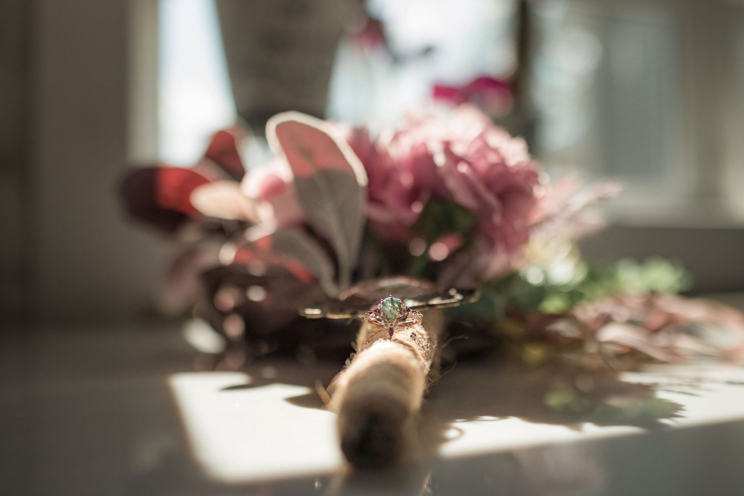Soft focus floral arrangements with pink blooms in natural window light.