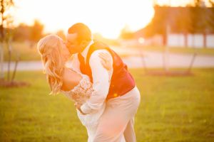 Romantic sunset portrait of couple embracing in golden evening light.