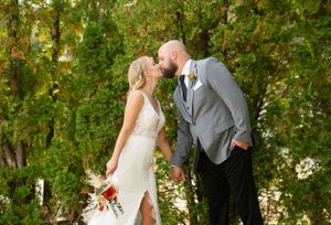 Romantic autumn wedding photo with golden leaves in the background.