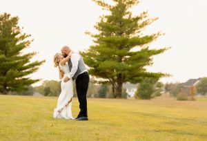Romantic sunset wedding photo with pine trees in the background.