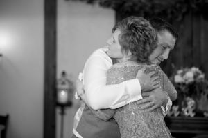 A tender black and white moment captured during an emotional wedding dance.