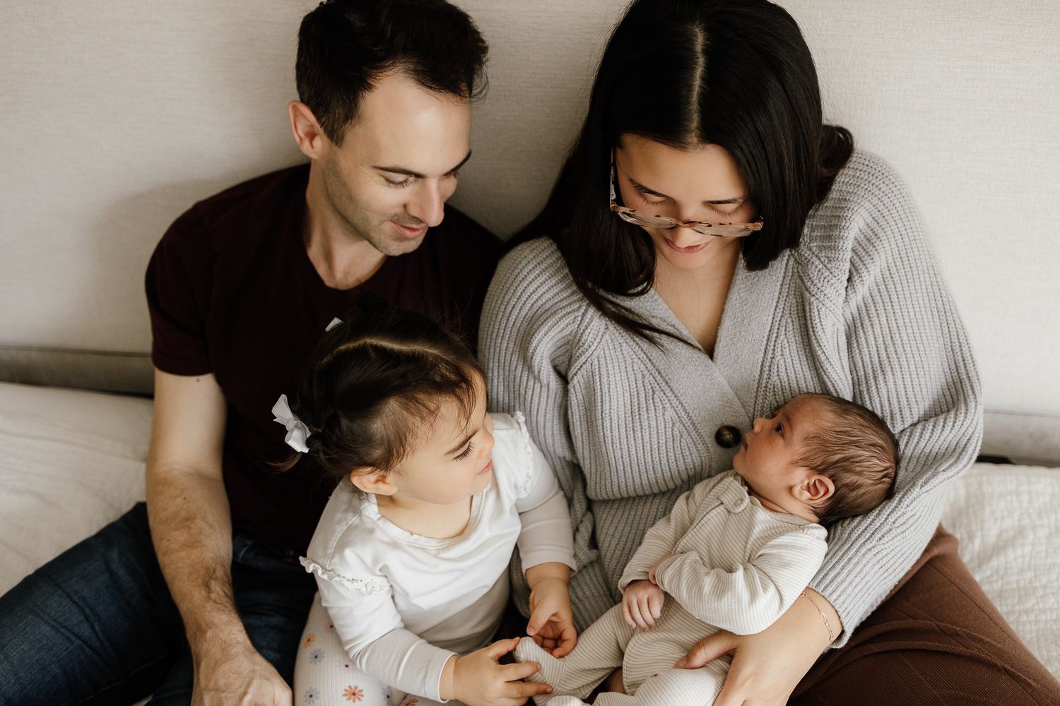 Newborn photography session in San Jose with a relaxed family lovingly interacting