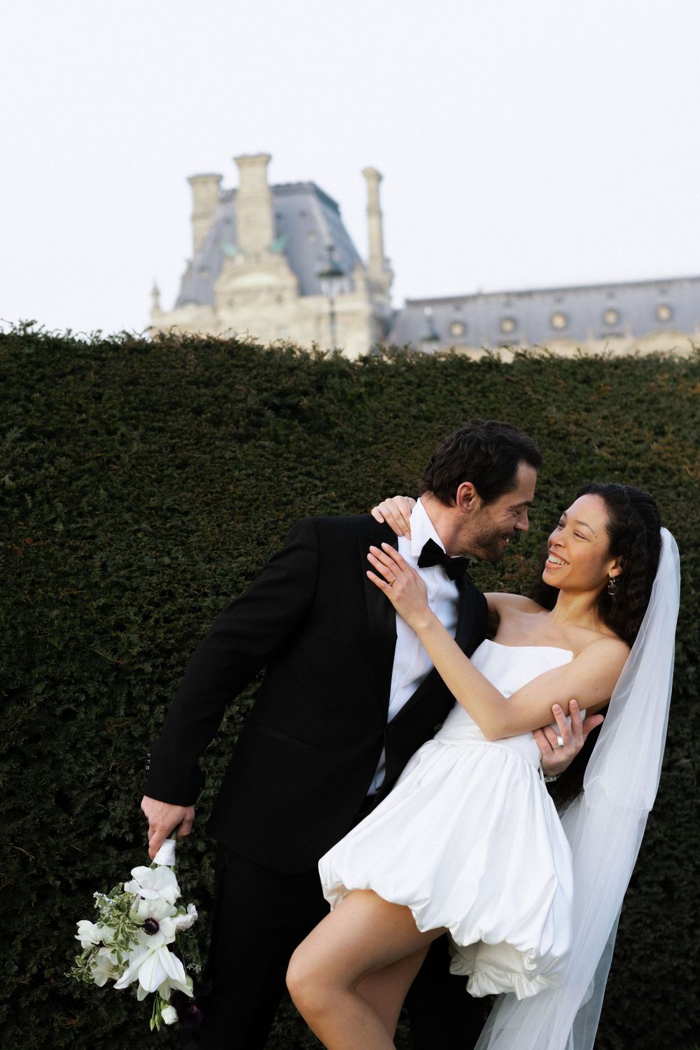 A romantic wedding photo session at Chateau de Chambord with formal gardens and French architecture in the background.