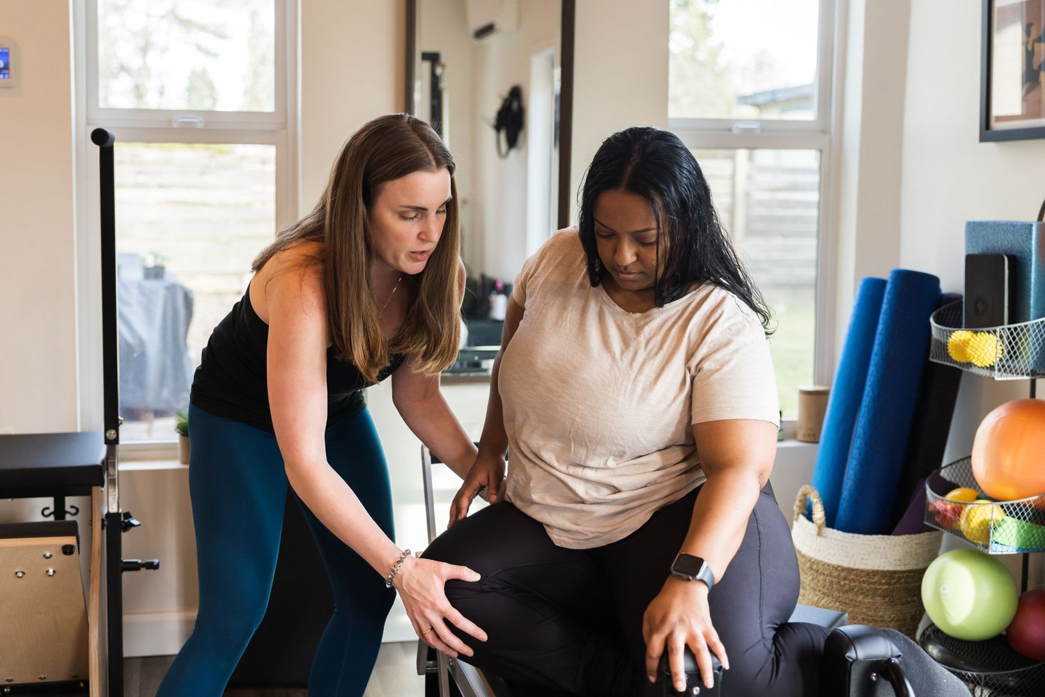 Physical therapist and patient work together during rehabilitation session in a bright clinic setting.