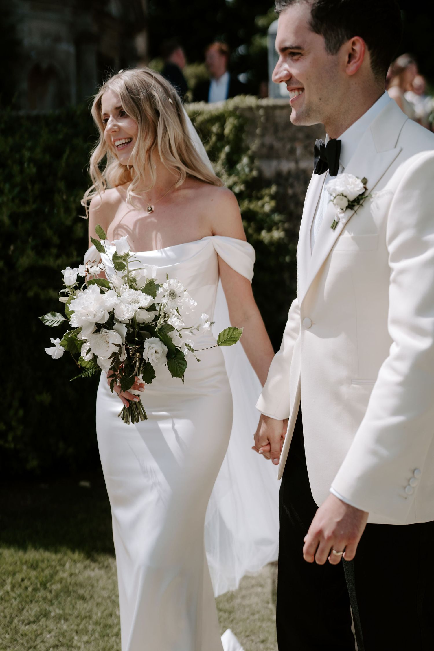 bride and groom walking through confetti tunnel at hasmwell house in bath