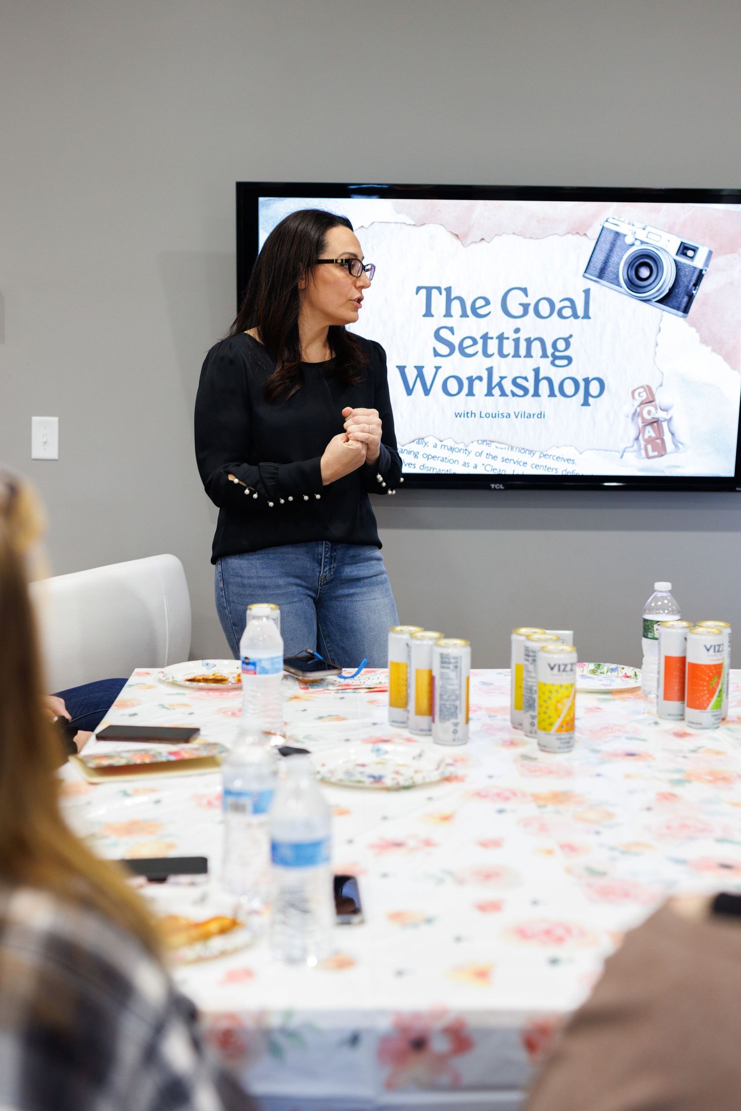 Goal setting workshop room with presentation screen and refreshments on decorated table.