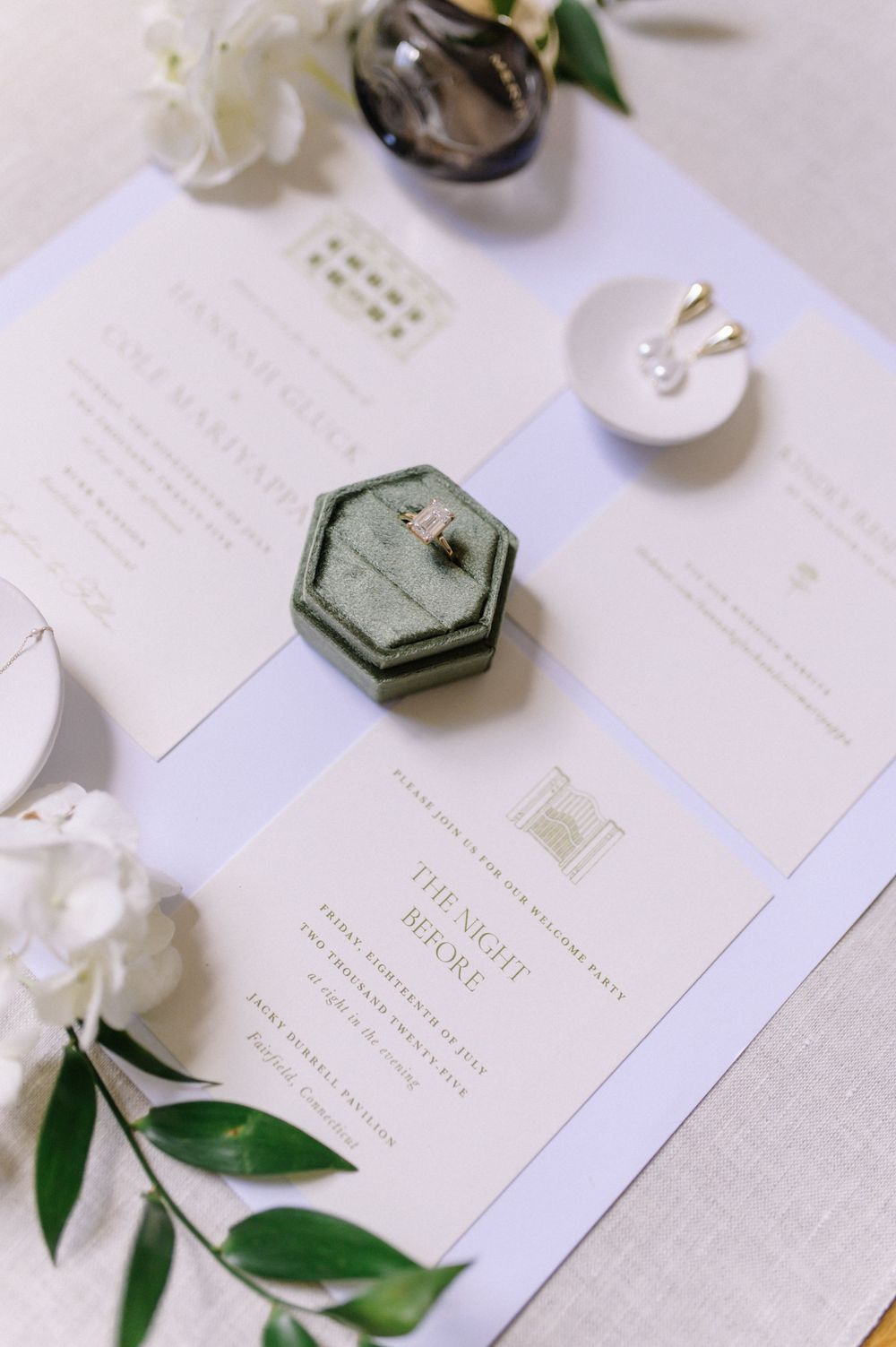 Wedding invitations and stationery with green accents and floral details on white background.