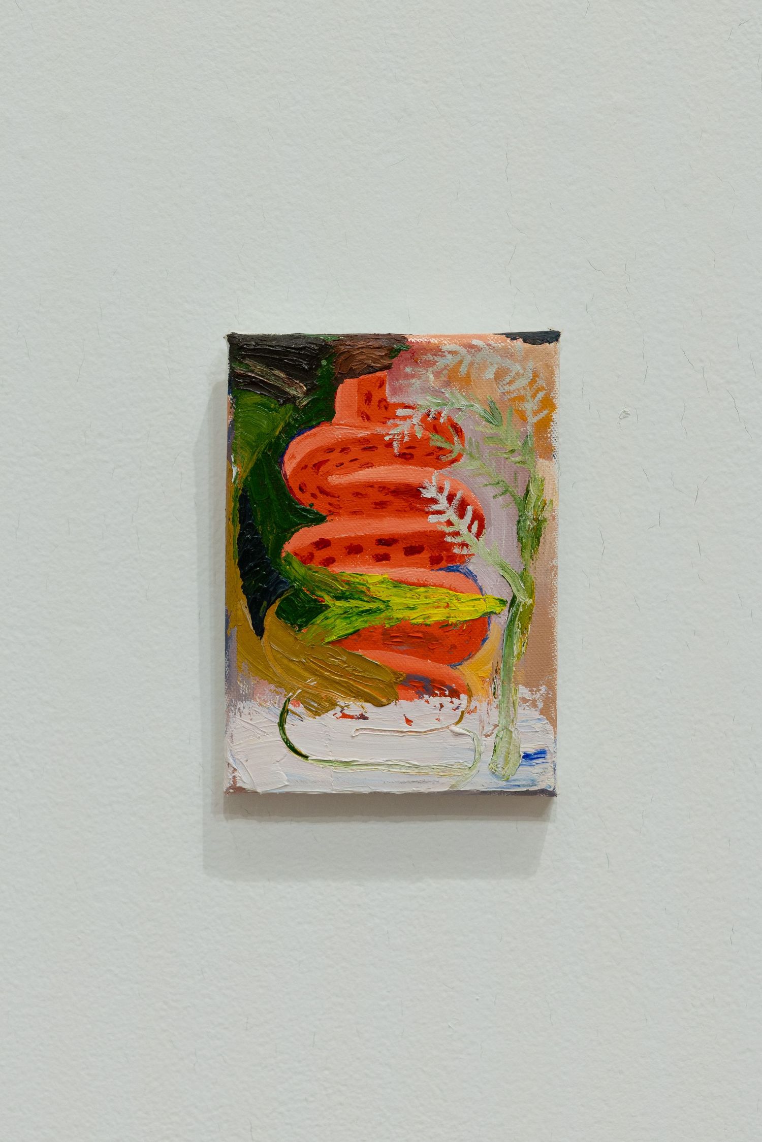 Small abstract painting with swirling orange, red and yellow brushstrokes against a white background mounted on a gray wall.