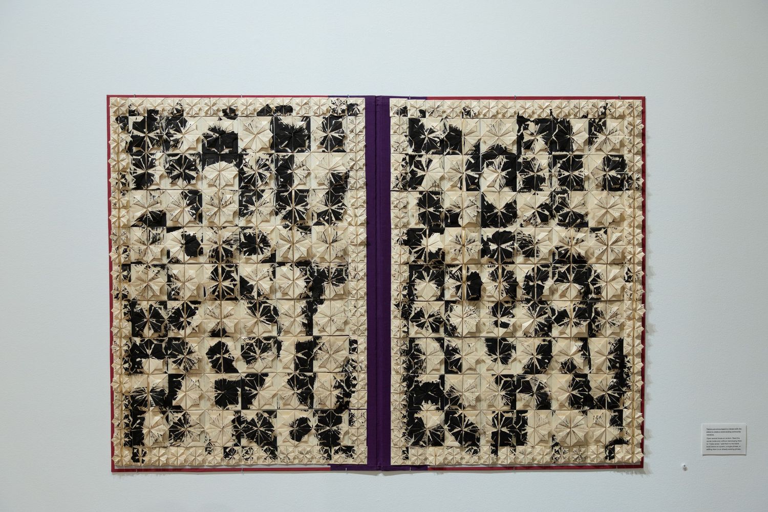 Abstract black and white polyptych artwork displayed on a gallery wall showing scattered organic patterns and shapes.