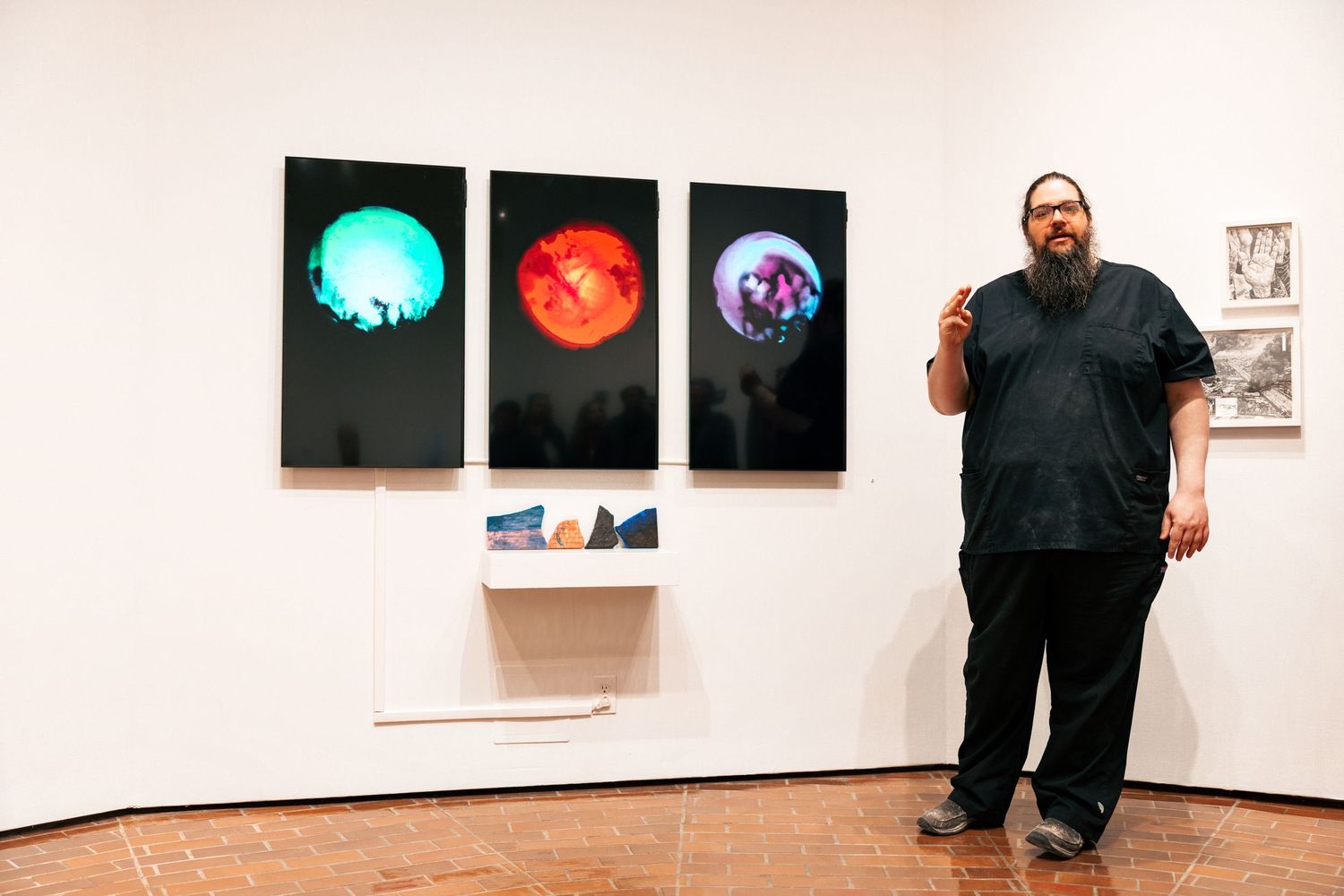 A series of gallery wall photos showing an art exhibition installation with white walls and mounted artwork.