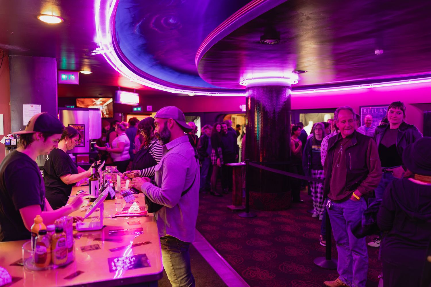 Crowded bar venue with purple neon lighting during Spokane Film Festival after-party event.