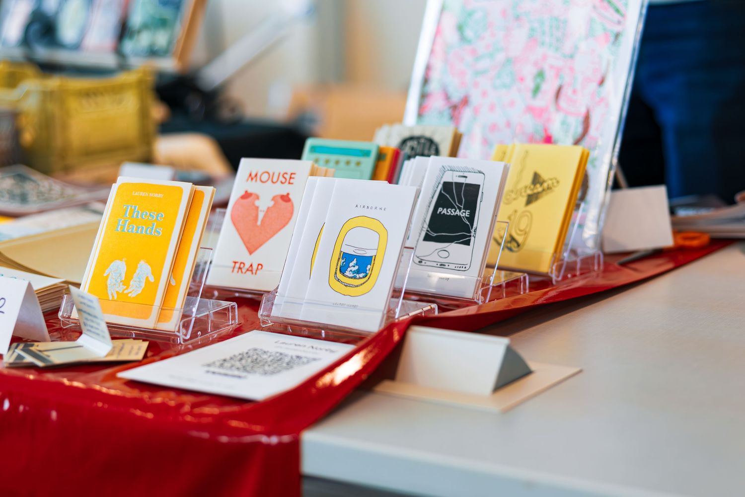 Rows of colorful greeting cards displayed on red shelves in a retail store setting.