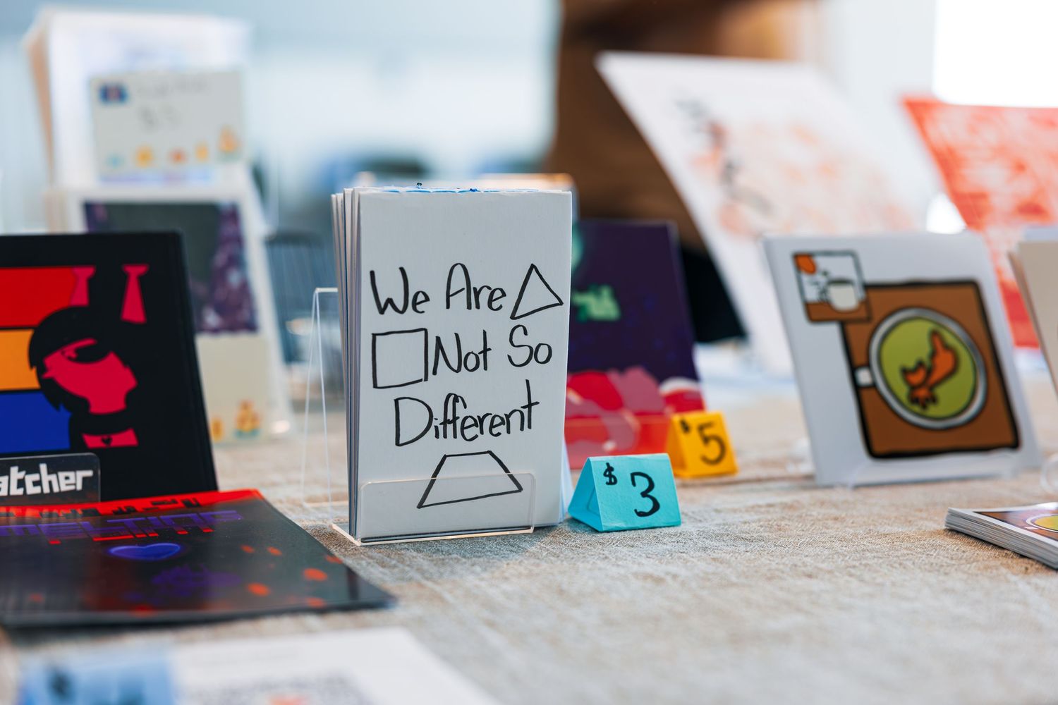 Row of colorful business cards and marketing materials displayed on a light surface in shallow focus.