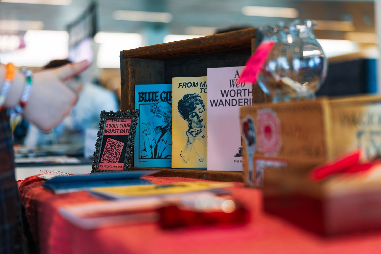 Colorful books and merchandise displayed on retail shelves in a bright store setting.