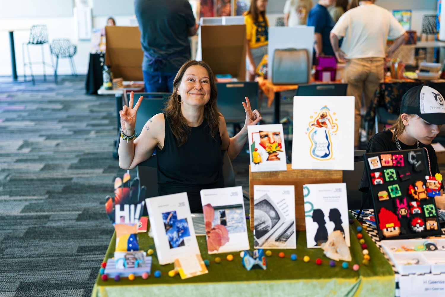 Students display colorful artwork and creative projects at a school art exhibition.